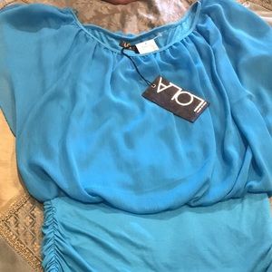 Loose fitted and then fitted at bottom shirt...